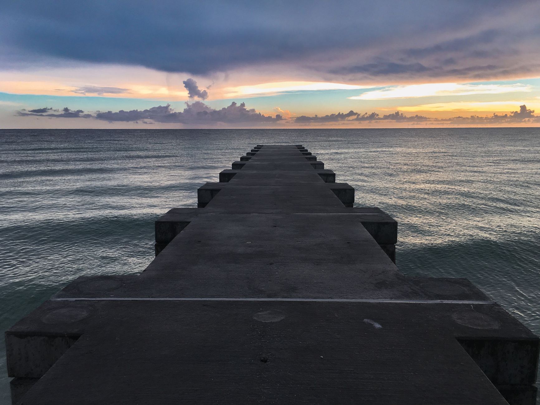Stunning view of a pier stretching into the ocean at sunset in Florida, USA.