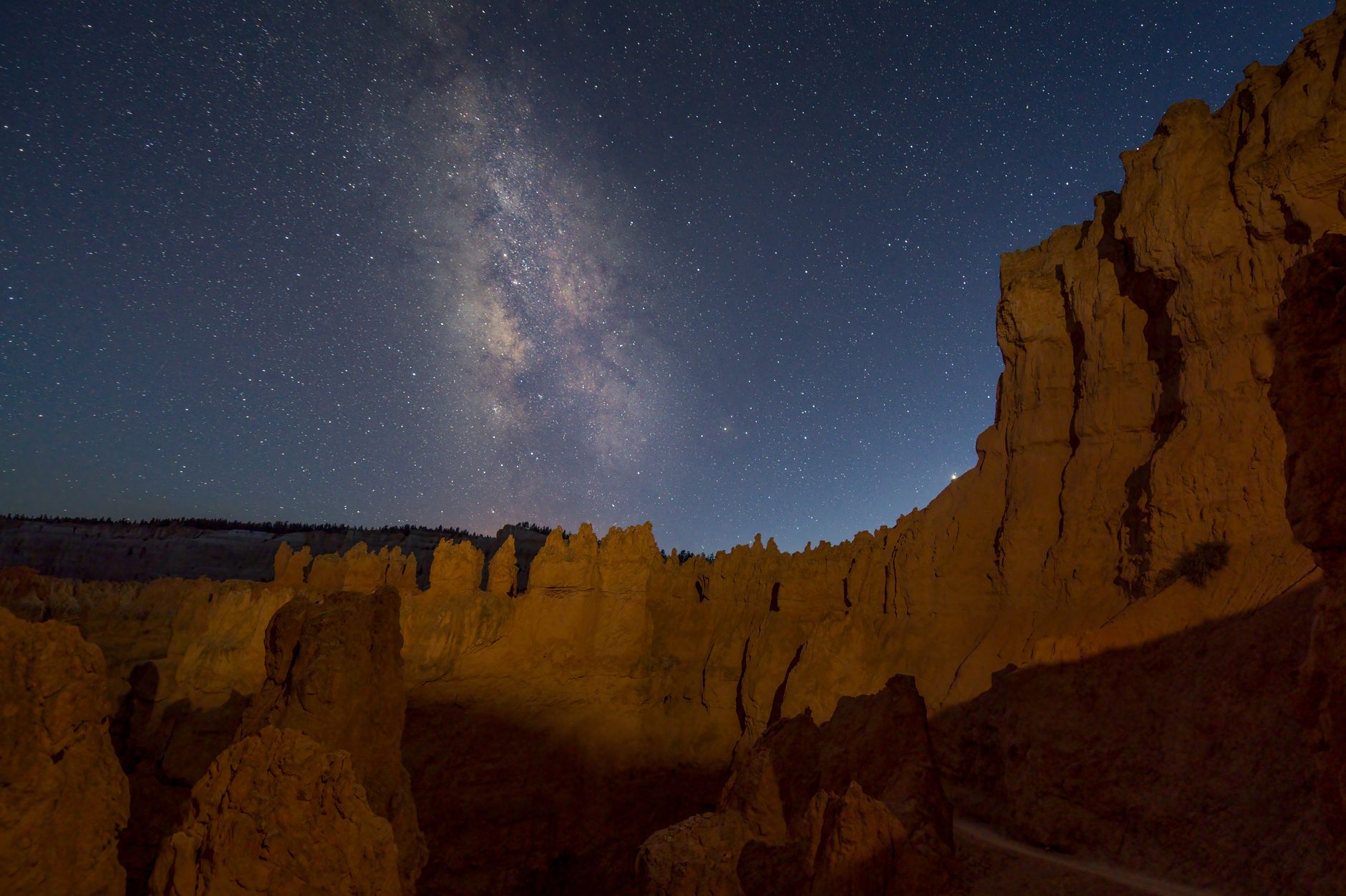 Captivating view of the Milky Way above Bryce Canyon's hoodoos, showcasing natural beauty at night.