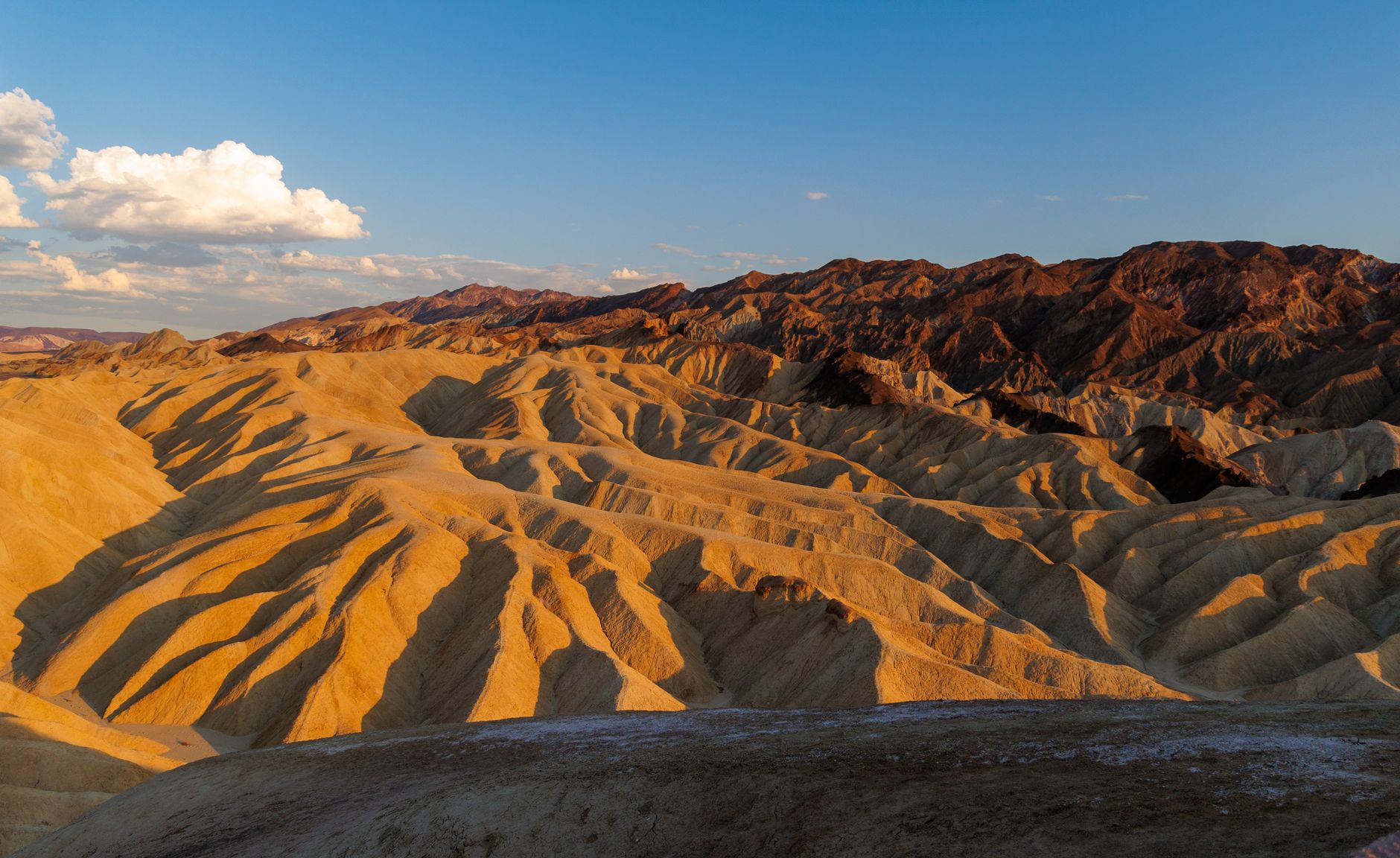 Golden hues of Zabriskie Point at sunset taken in Death Valley National Park, showcasing desert beauty.