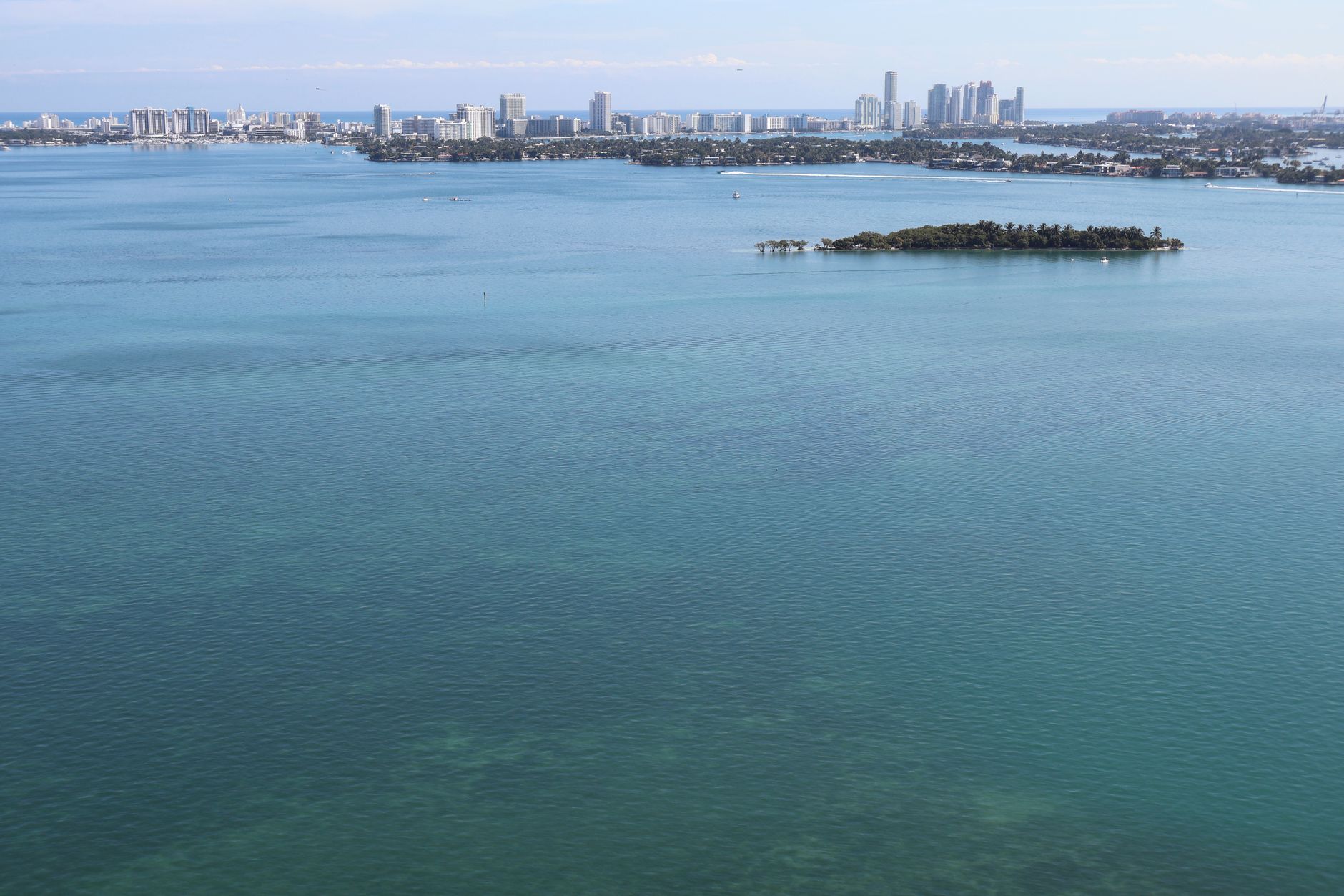 Stunning aerial view of Miami skyline and serene coastal waters.