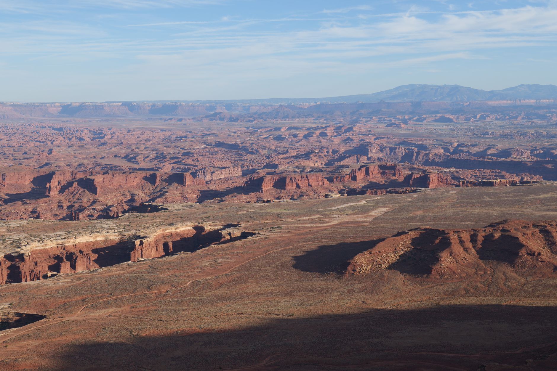 A stunning landscape of red rock canyons under a clear blue sky in Canyonlands National Park.