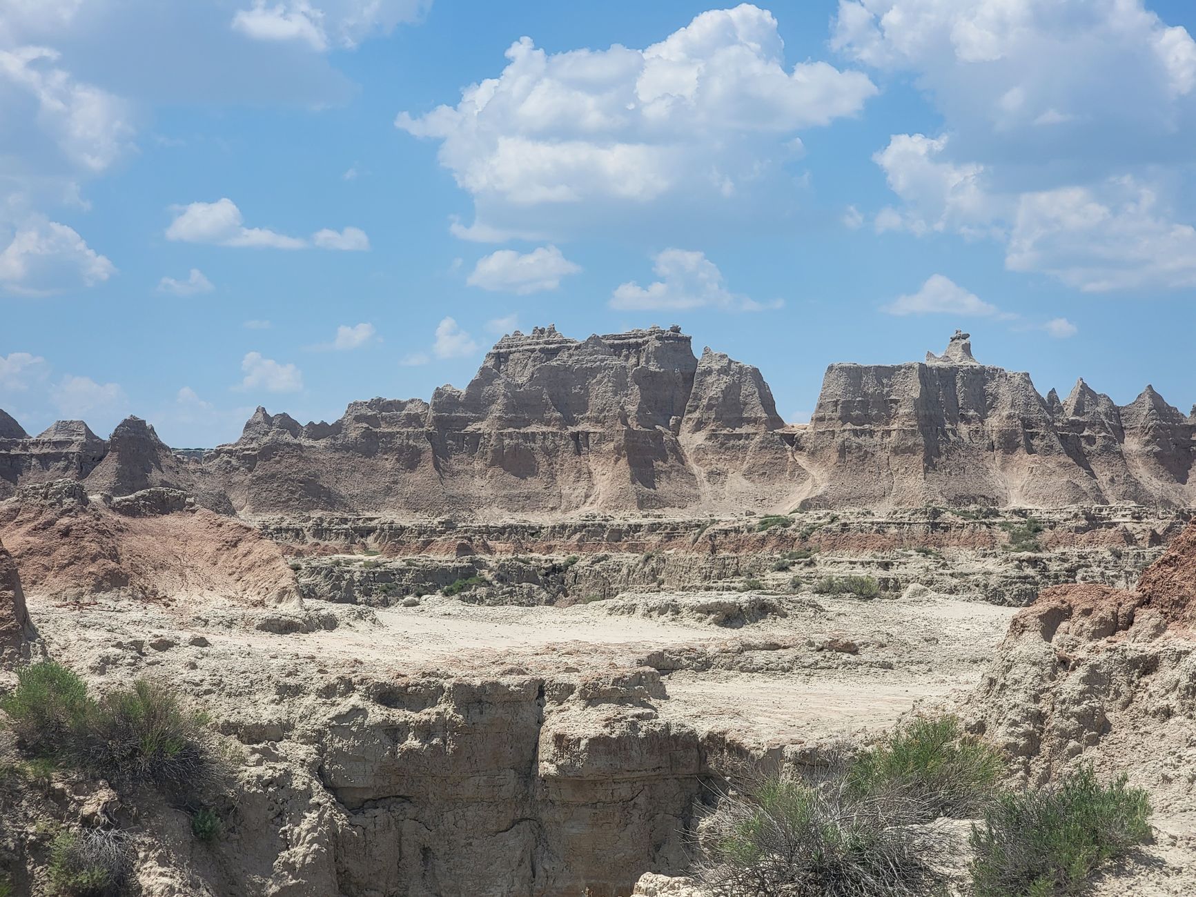 Explore a breathtaking desert landscape featuring unique rock formations under a bright blue sky.