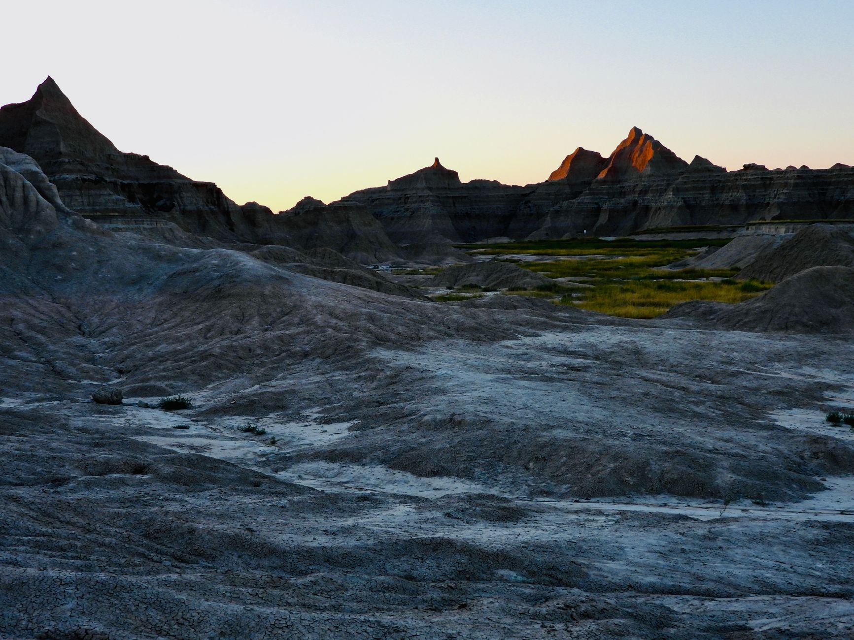 Stunning Badlands landscape showcasing rugged rock formations during dusk.