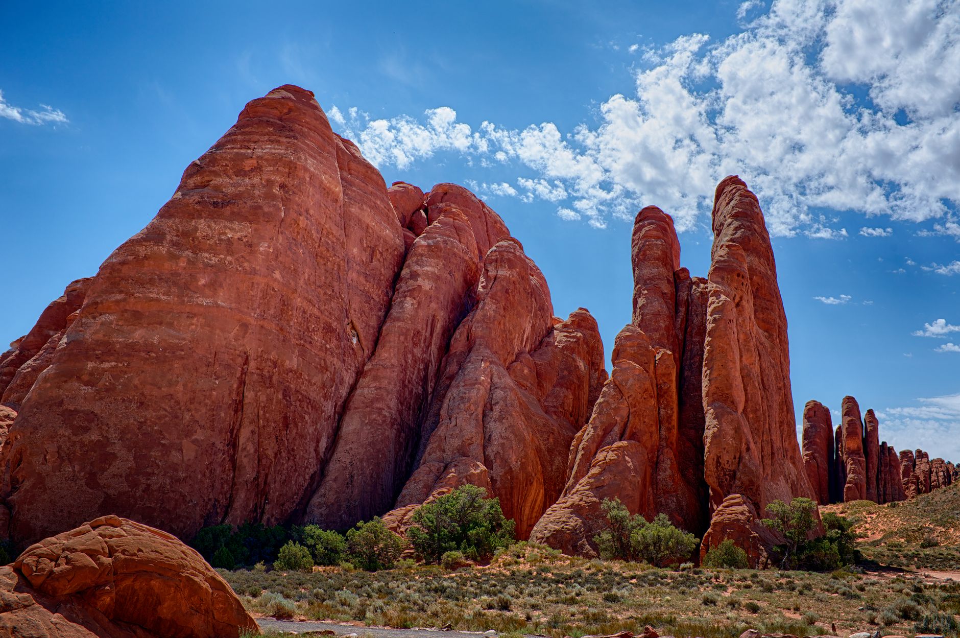 Stunning red rock formations under a bright blue sky in Emery County, Utah.