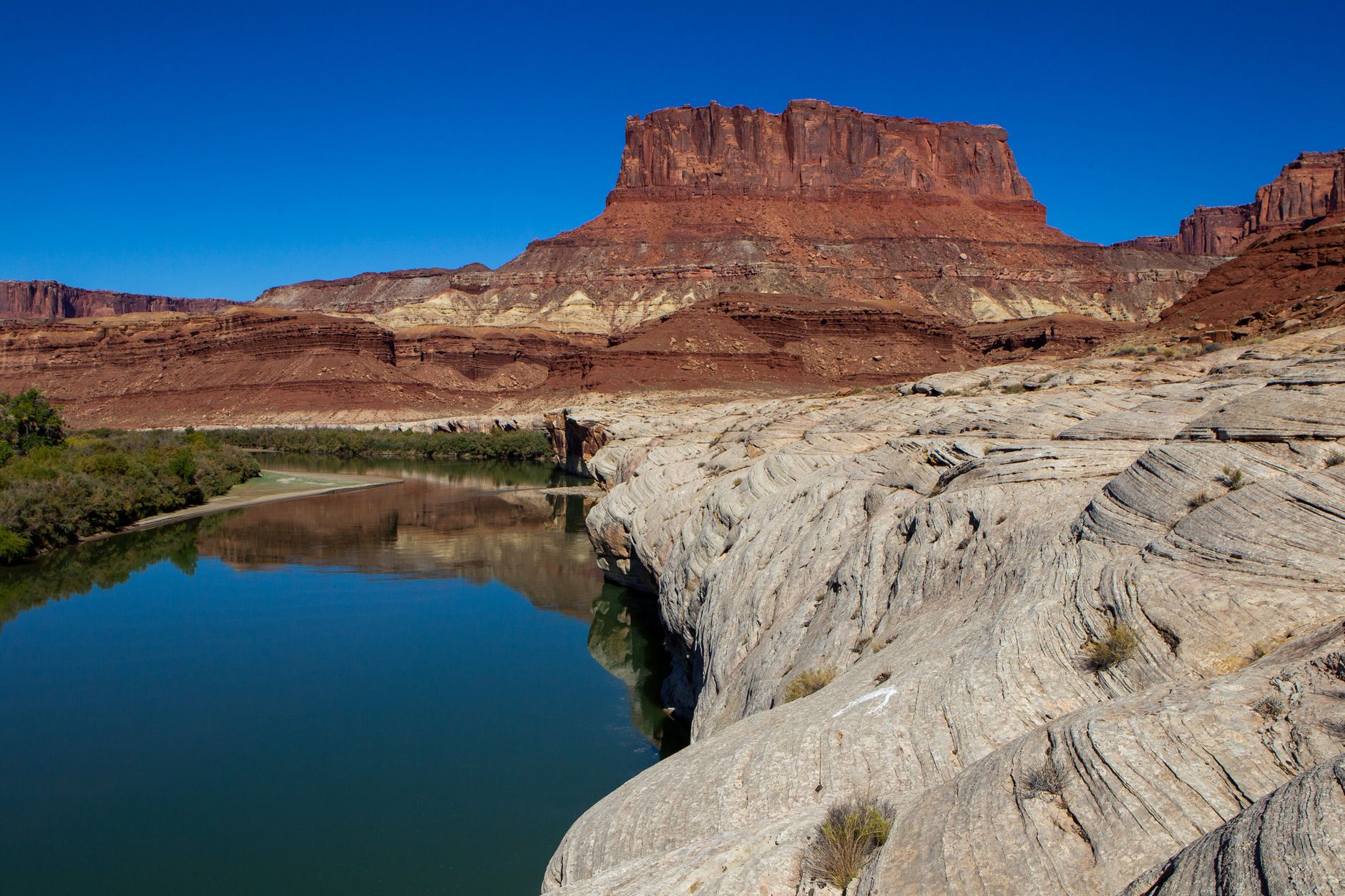 Stunning landscape of Colorado River with eroded rocks and red cliffs in Moab, Utah.