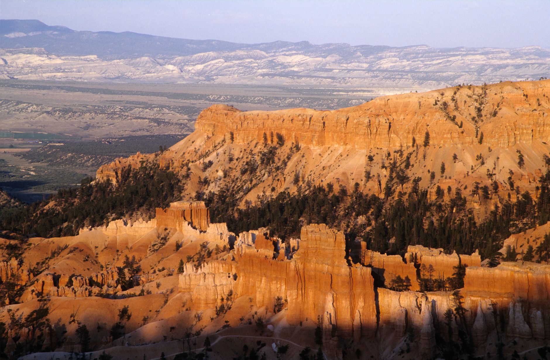 A breathtaking aerial view of Bryce Canyon's eroded rock formations at sunset.