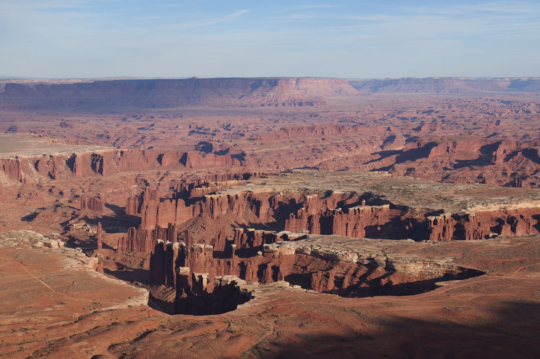 Stunning aerial view of Canyonlands National Park in Utah showing its unique red rock formations and vast landscape.