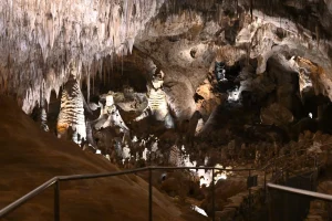 Photo of the Big Room with cave formations and the trail.