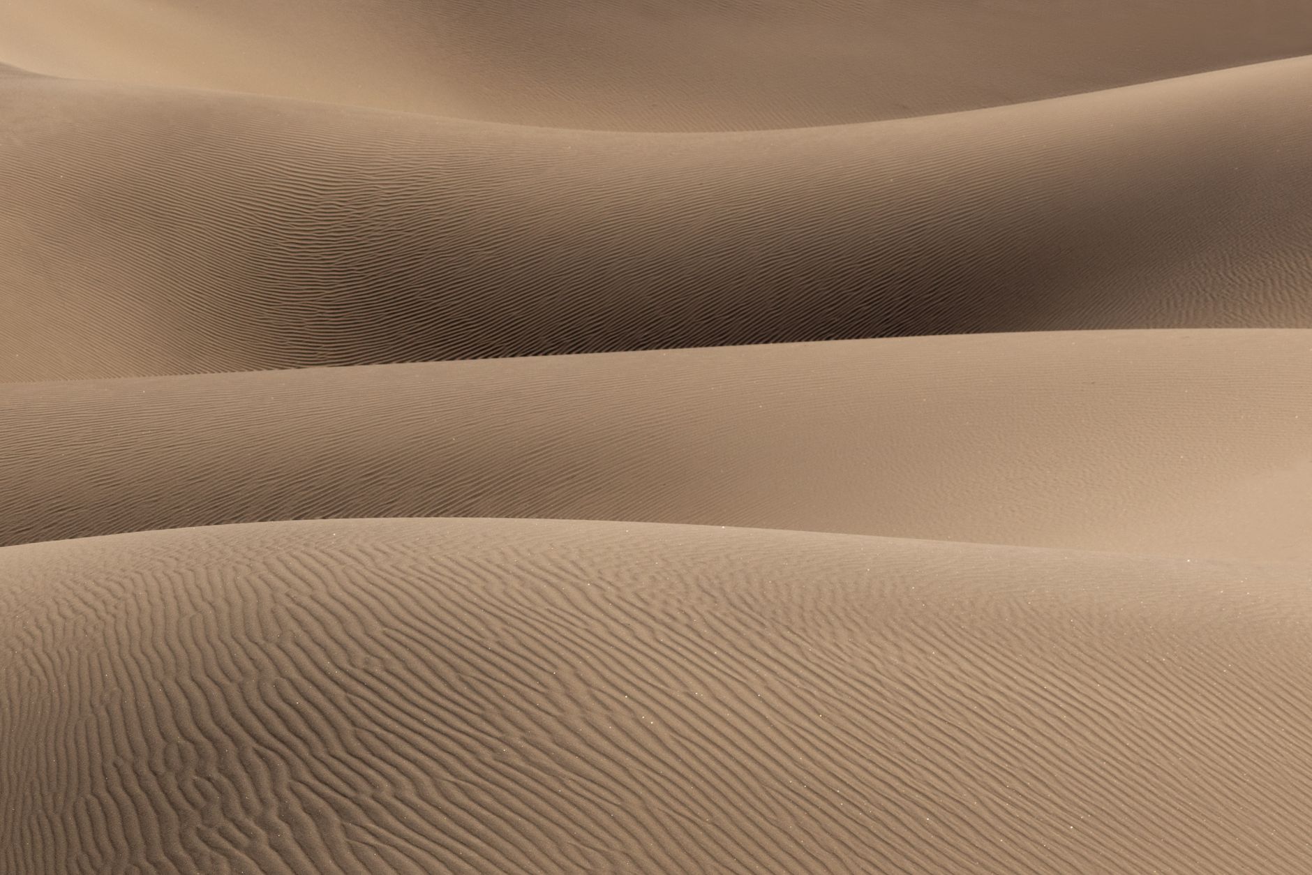 Rippling sand dunes in Death Valley create a minimalist and calming landscape.