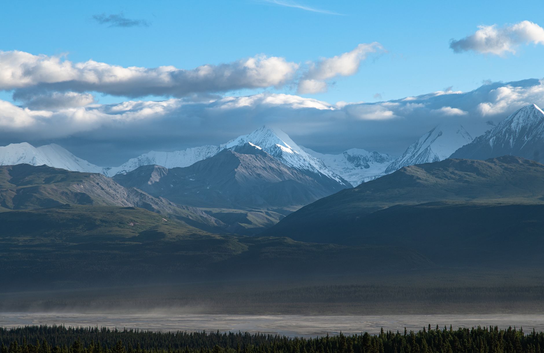 Breathtaking view of Alaska's snow-capped mountains under a clear sky. Perfect for travel inspiration.