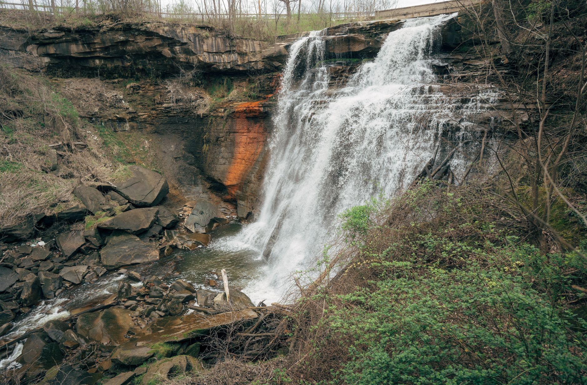 A stunning view of Brandywine Falls cascading over rock formations in Ohio's Cuyahoga Valley National Park.