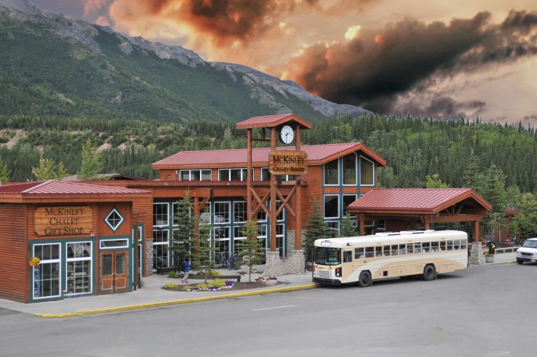 Scenic view of McKinley Chalet Resort in Healy, Alaska with a dramatic cloudy sky backdrop.