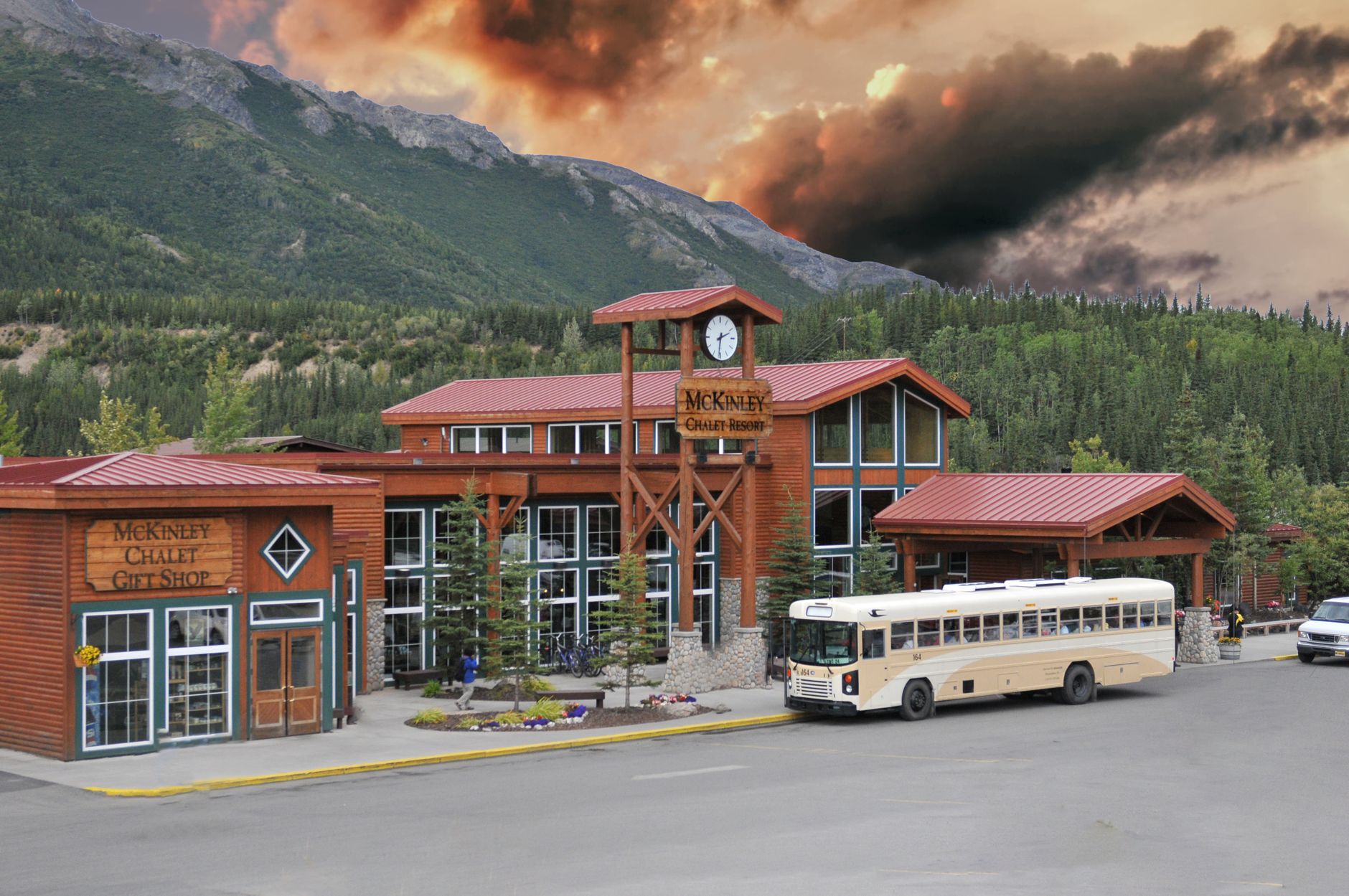 Scenic view of McKinley Chalet Resort in Healy, Alaska with a dramatic cloudy sky backdrop.