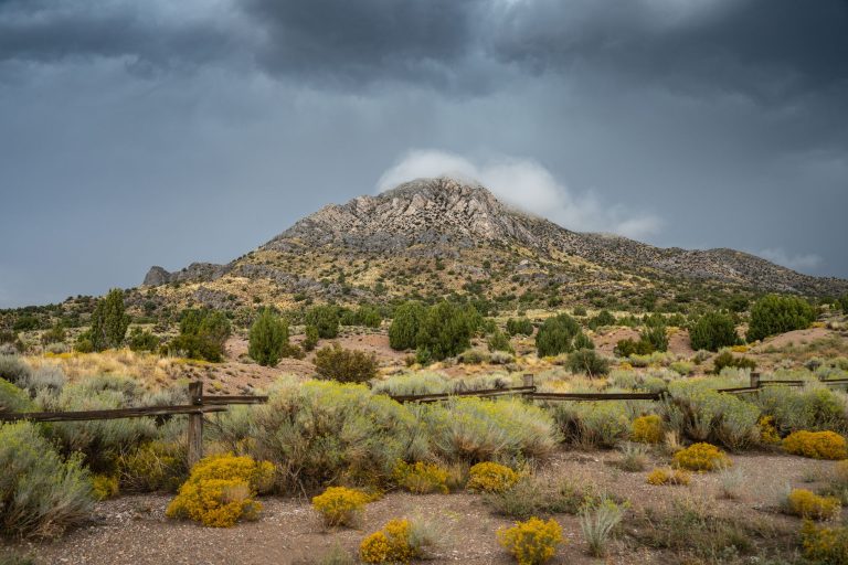 Stunning view of a rugged mountain under stormy skies in Nevada's rural landscape.
