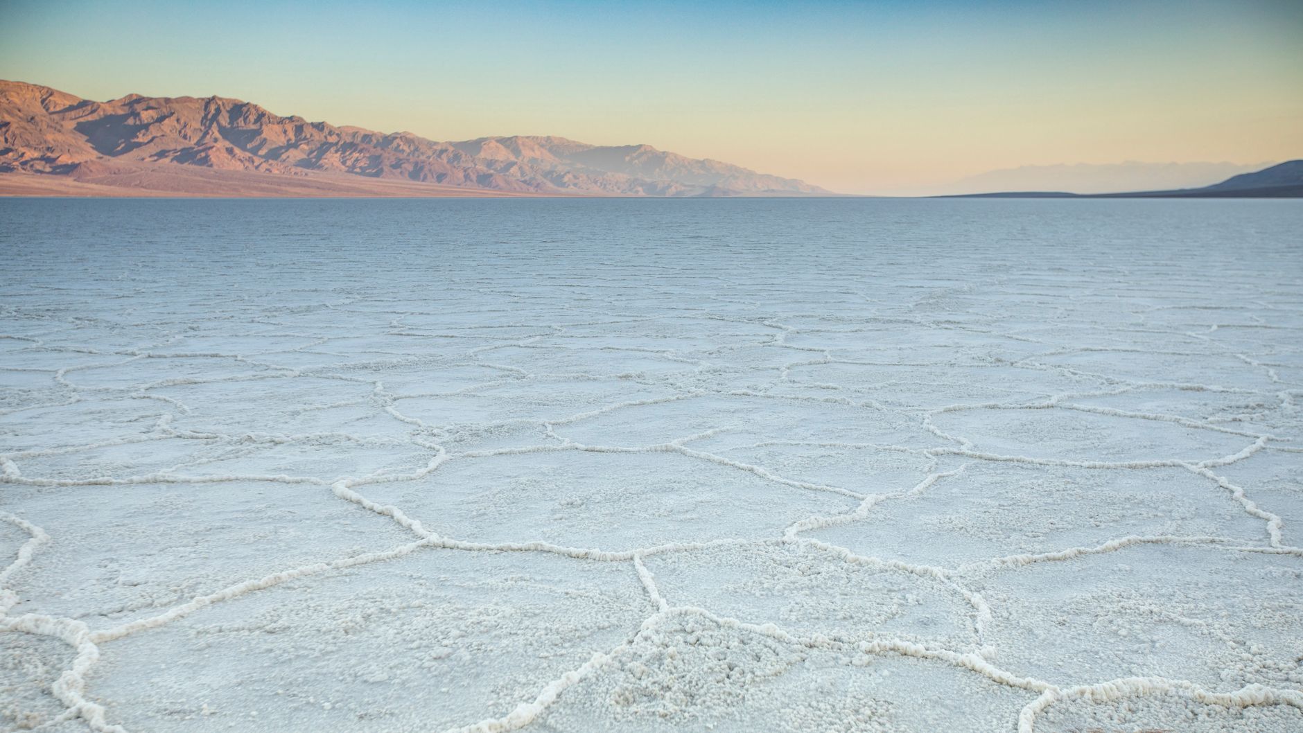 Stunning view of the salt flats at Badwater Basin in Death Valley during sunset.