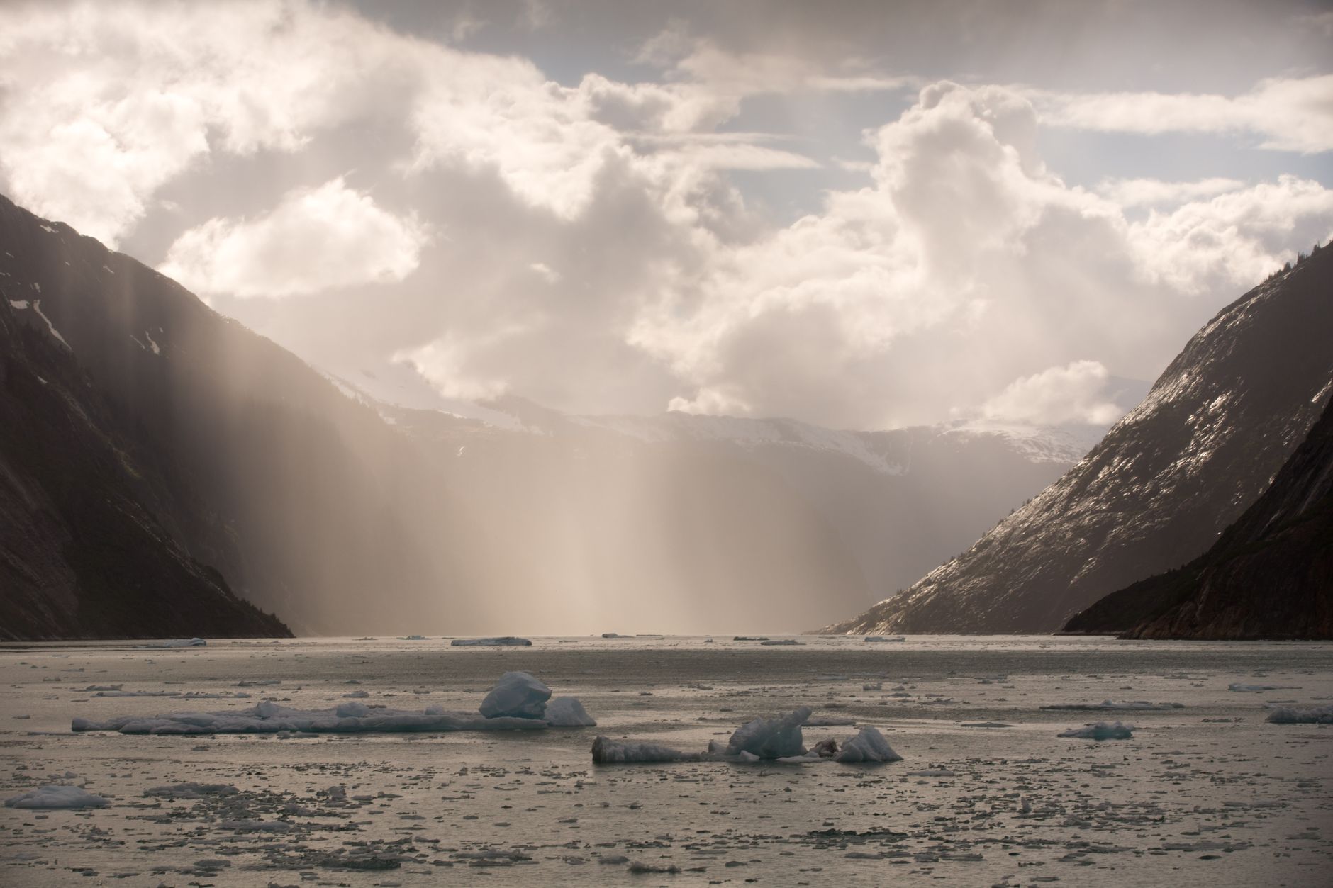 Captivating view of icebergs and glaciers under a dramatic sky in Juneau, Alaska.