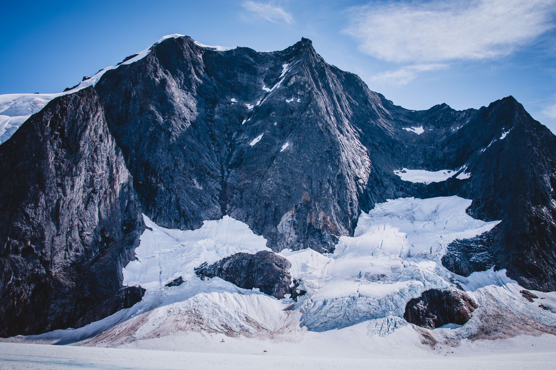 Stunning view of a snow-covered mountain peak and glacier showcasing natural beauty and rugged terrain.