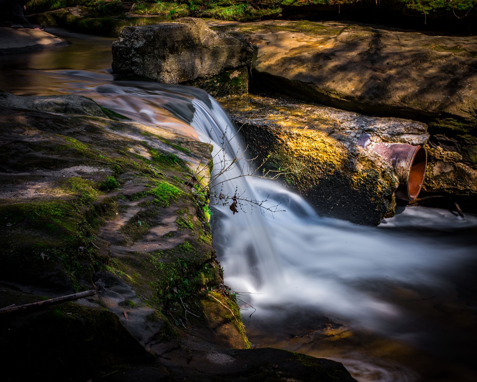 Peaceful waterfall cascading over rocks in a forest in Mansfield, Ohio, USA. Perfect for nature and travel visuals.