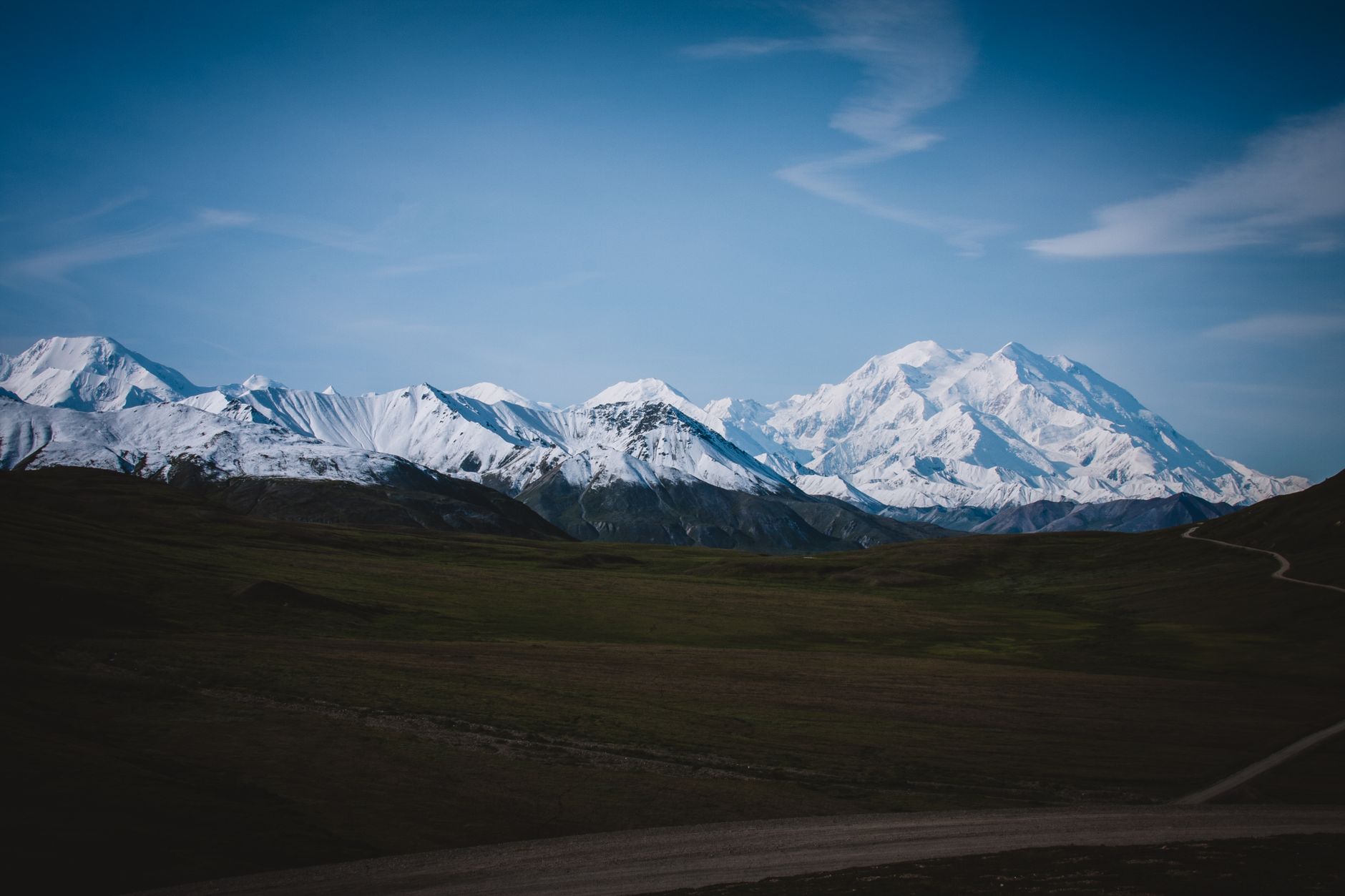 A stunning view of majestic snow-capped mountains in a remote wilderness, capturing natural beauty and tranquility.