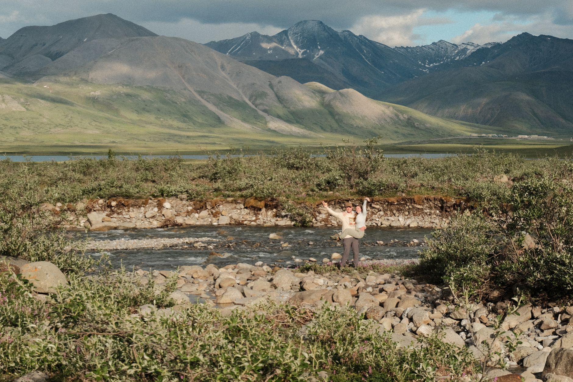 Beautiful mountain landscape with travelers near a river, perfect for nature lovers.