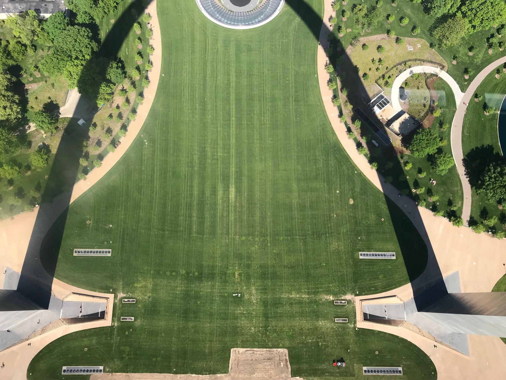 Aerial view showcasing the greenery and pathways of Gateway Arch National Park in St. Louis.