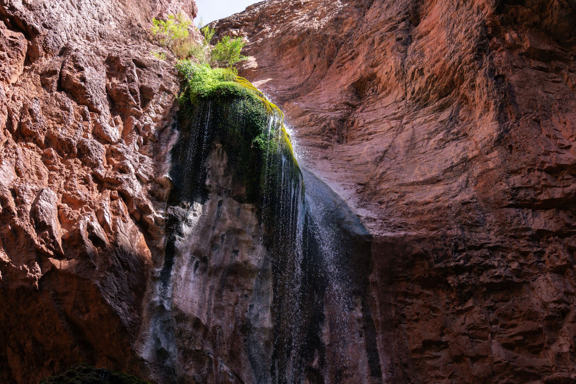 Experience the natural beauty of Ribbon Falls cascading down the Grand Canyon rock formations.