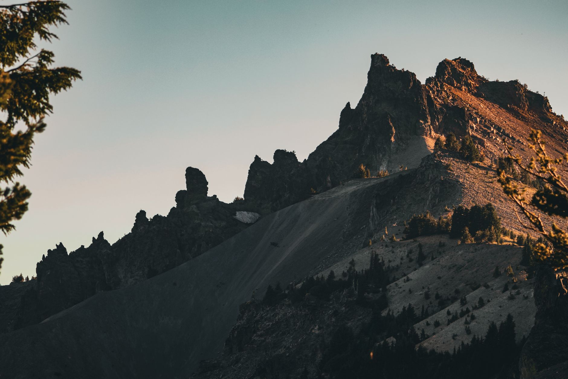 Majestic sunset view of rugged mountain peaks at Crater Lake National Park in Oregon.