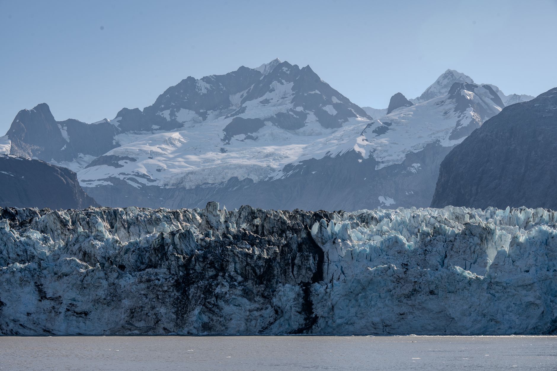Breathtaking view of Glacier Bay with rugged ice formations and snow-capped mountains in Alaska.