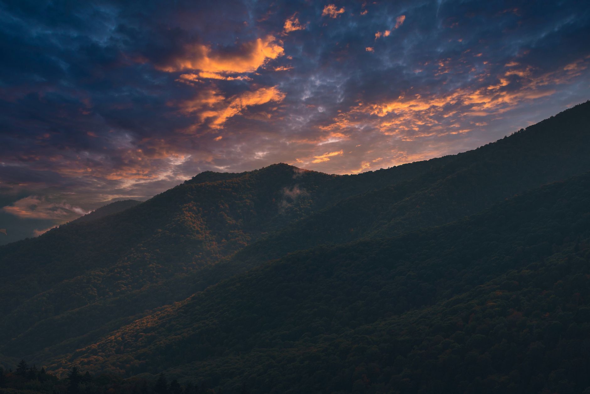 Breathtaking sunset over the Smoky Mountains with vivid skies and silhouetted peaks.