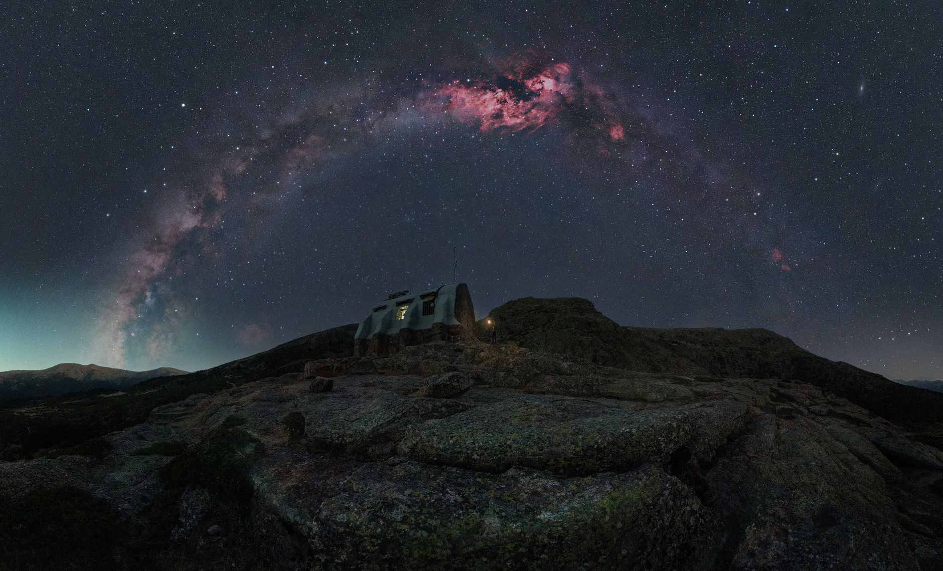 Stunning view of Milky Way above a remote mountain observatory at night.